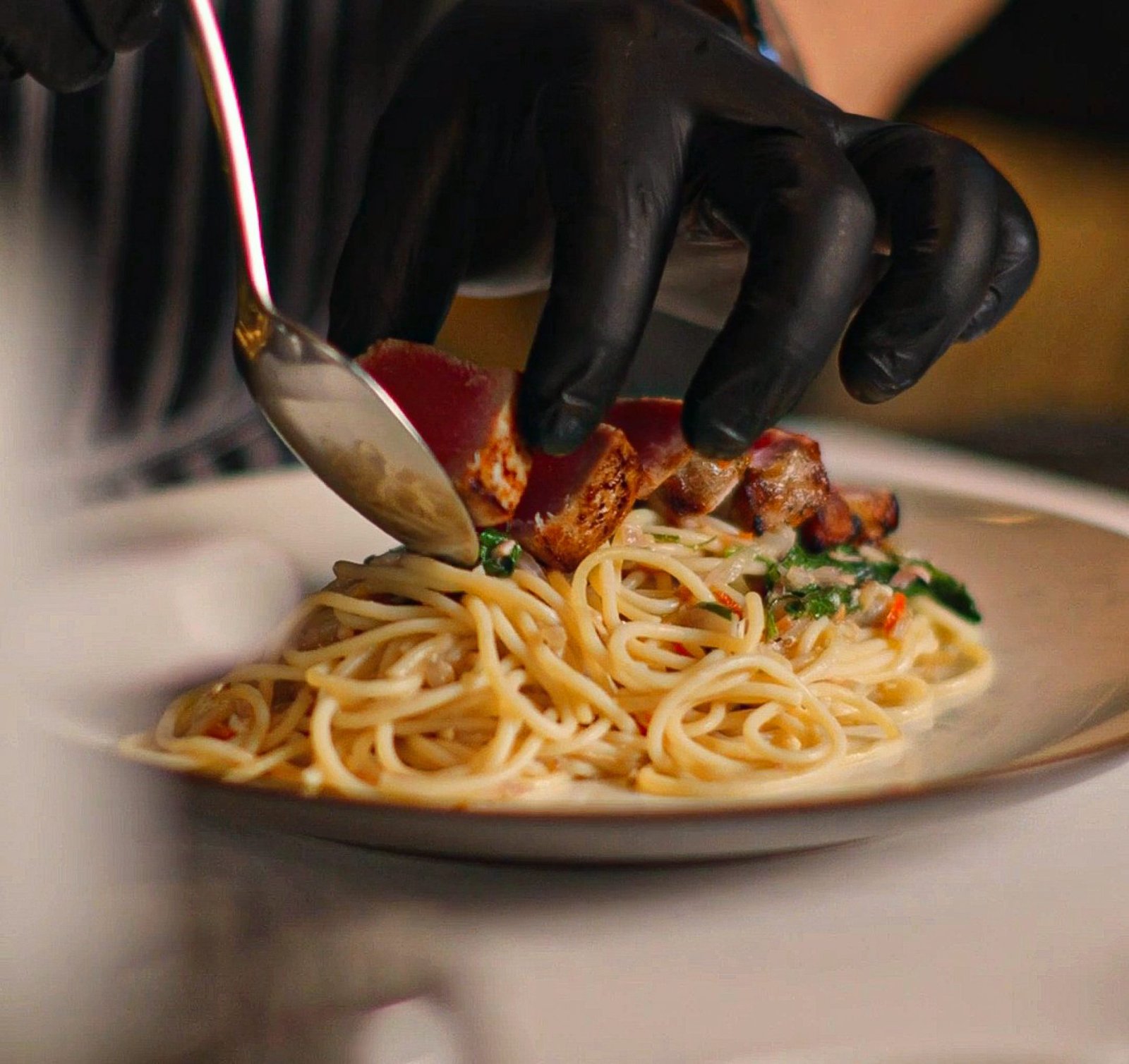 Chef plating a gourmet pasta dish at ON J Restaurant, a dining highlight at Ayatara Villa Ubud Kintamani Bali